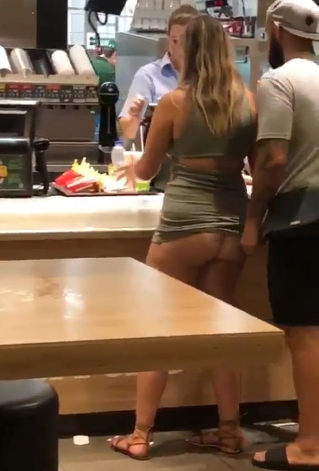 At McDonalds counter, she ordered a HugeMac with extra salami and creamy sauce #7oK3ZiTS
