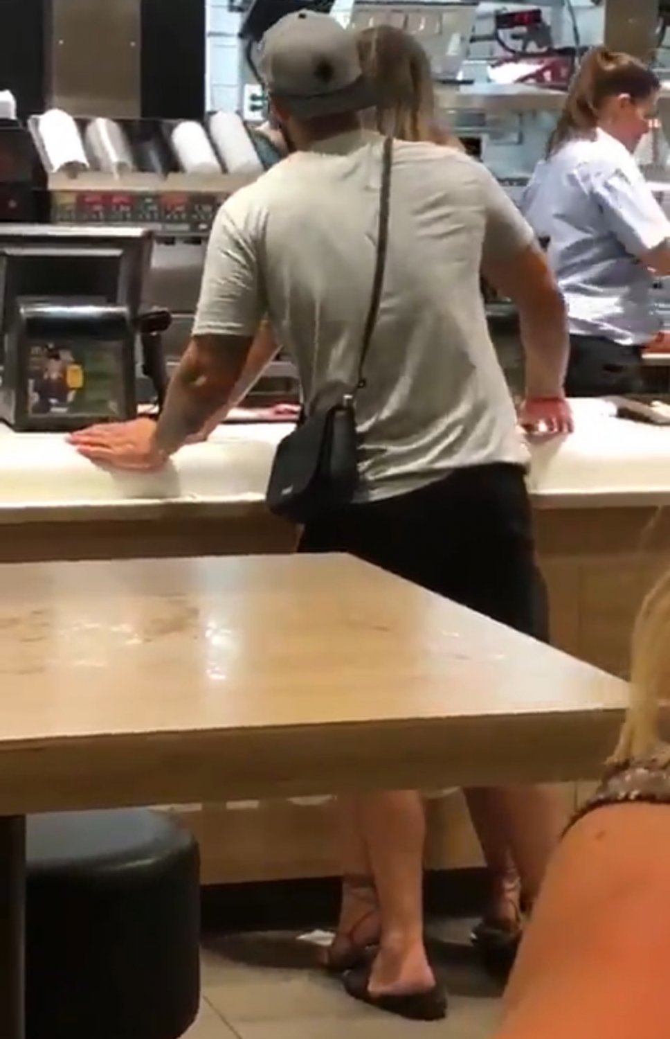 At McDonalds counter, she ordered a HugeMac with extra salami and creamy sauce #8U1XaTfH